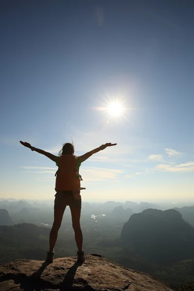 cheering woman hiker