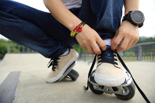 skateboarder tying shoelace