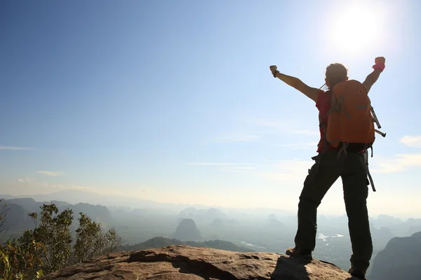 cheering woman hiker