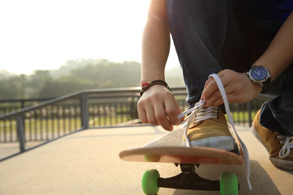 Skateboardista vázání tkaničky — Stock fotografie