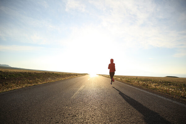 Young fitness woman runner running 