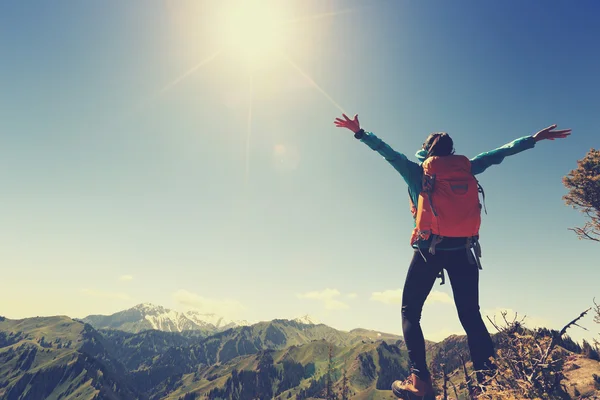 Cheering successful woman backpacker — Stock Photo, Image