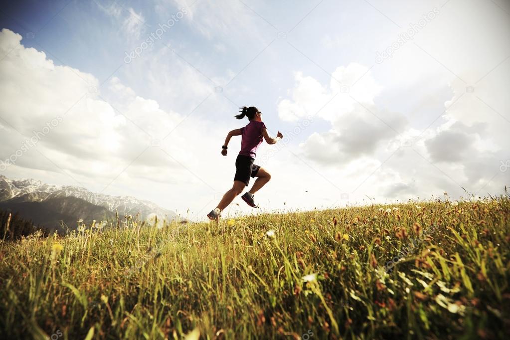 trail runner running on peak 