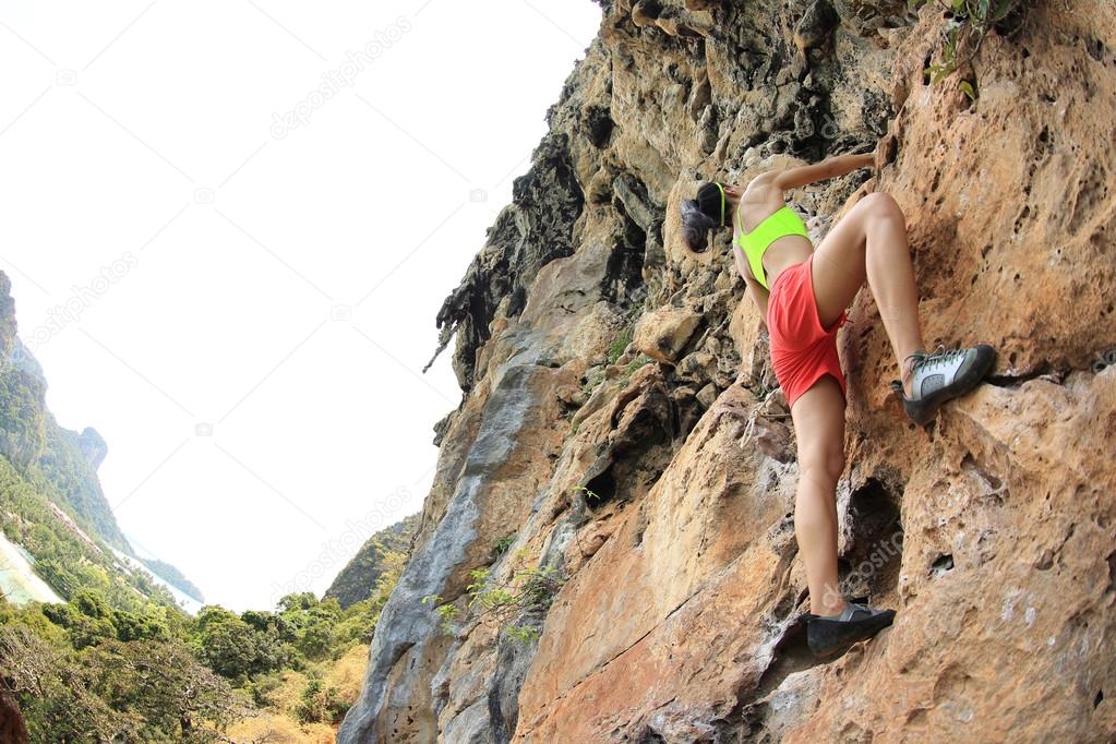 woman climbing at seaside