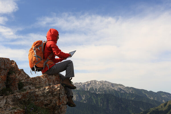 woman backpacker using digital tablet