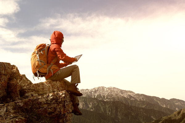 woman backpacker using digital tablet