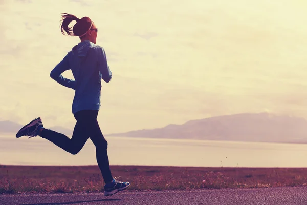 Woman running on road — Stock Photo, Image