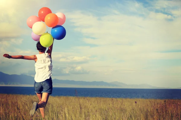 Woman with colored balloons — Stock Photo, Image