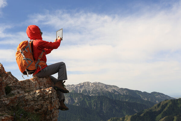 woman backpacker using digital tablet