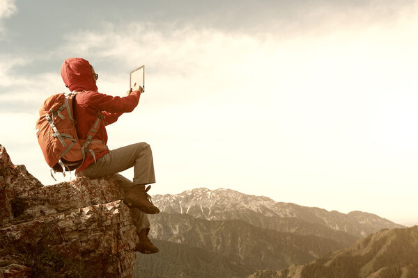 woman backpacker using digital tablet