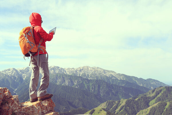 woman backpacker using digital tablet