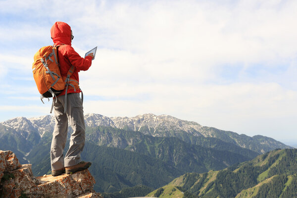 woman backpacker using digital tablet
