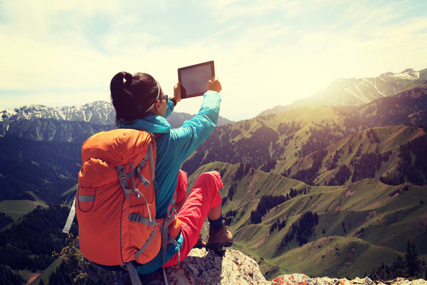 woman backpacker using digital tablet