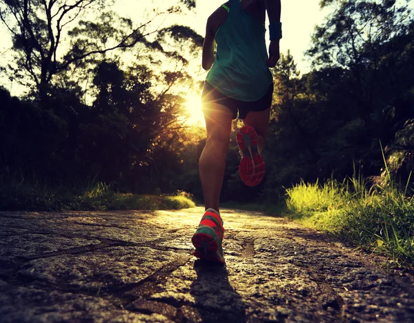 athlete running on forest trail