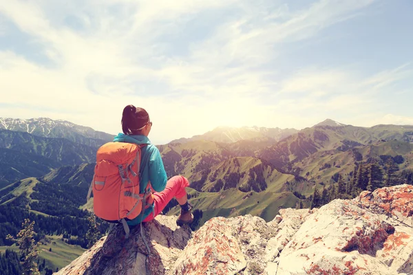 Dağ tepe üzerinde oturan backpacker — Stok fotoğraf