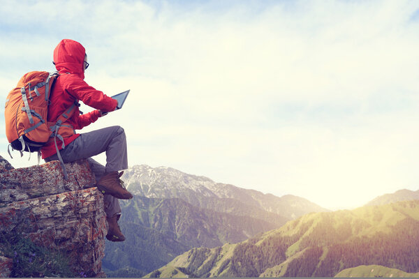  successful backpacker taking photo