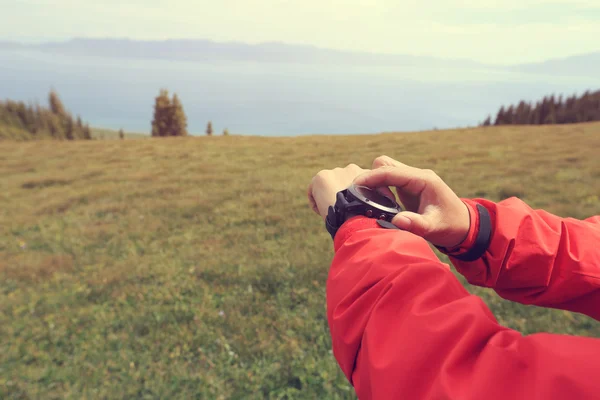 Woman hiker checking the altimeter — Stock Photo, Image