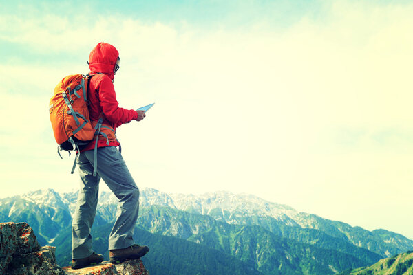 woman backpacker using digital tablet