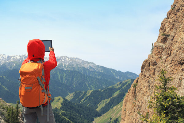 woman backpacker using digital tablet