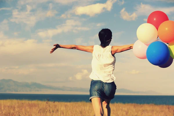 Woman with colored balloons outdoors — Stock Photo, Image