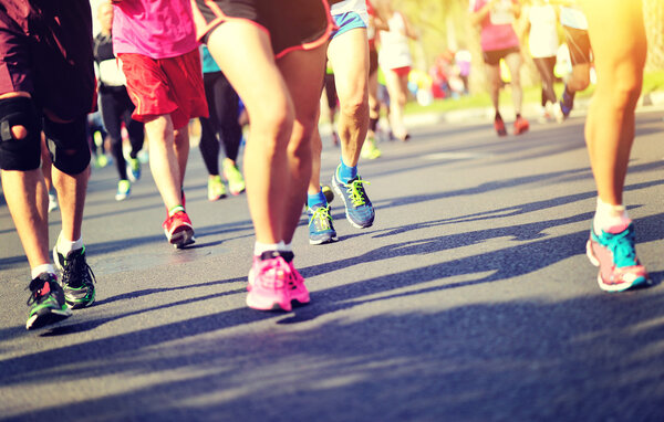 Unidentified marathon athletes legs running 