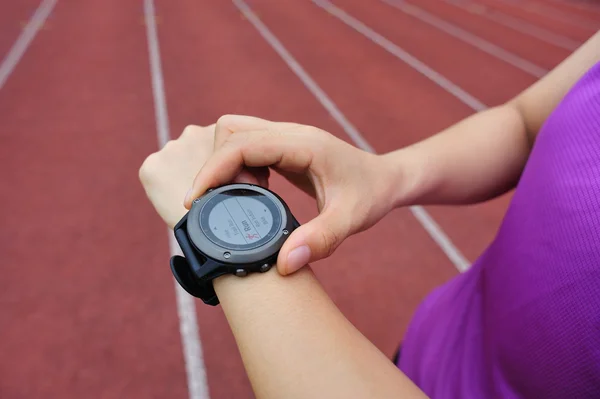 Runner looking at sports smart watch — Stock Photo, Image