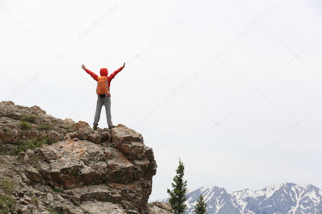 cheering woman hiker open arms