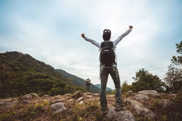 Woman hiker hiking in winter tropical mountains