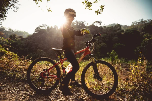 Woman Cyclist Set Her Smartwatch Cycling Sunrise Winter Forest Trail — Stock Photo, Image