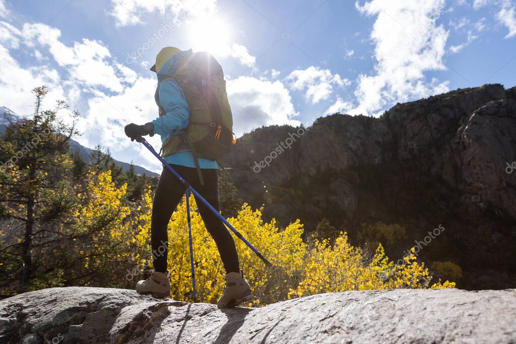 Woman backpacker hiking  in beautiful winter mountains