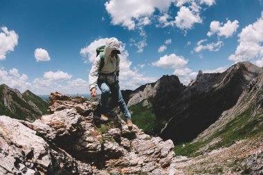 Başarılı kadın sırt çantalı dağda yürüyüş yapıyor.