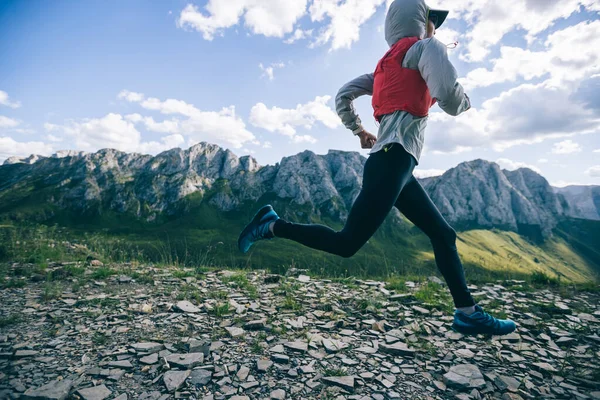 Woman ultramarathon runner running at mountain top