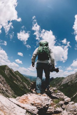 Yüksek rakımlı dağın tepesinde kamerası olan fotoğrafçı
