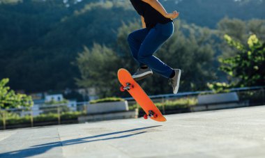 Kaykaycı şehir dışında kaykay yapıyor.