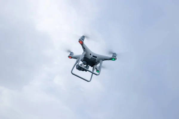 White drone with camera flying in summer mountain top