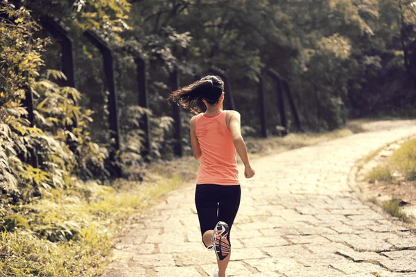 Young fitness woman running at forest trail — Stock Photo, Image