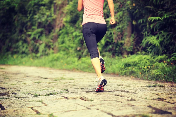Young fitness woman running at forest trail — Stock Photo, Image