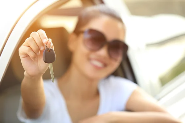 Happy woman driver hold car keys in her new car — Stock Photo, Image