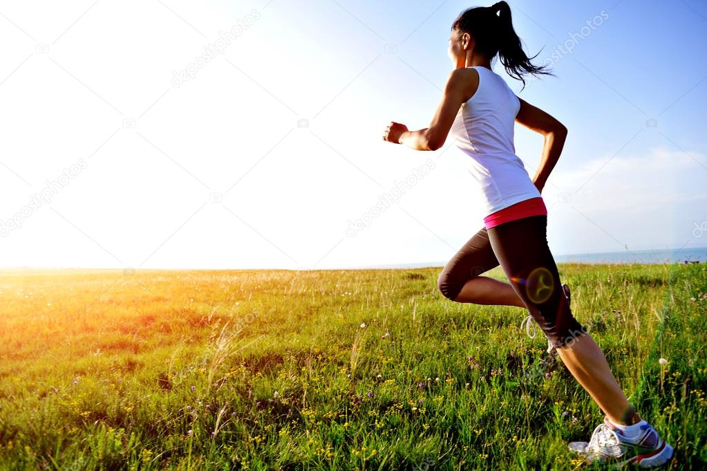 Runner athlet running on grass seaside.
