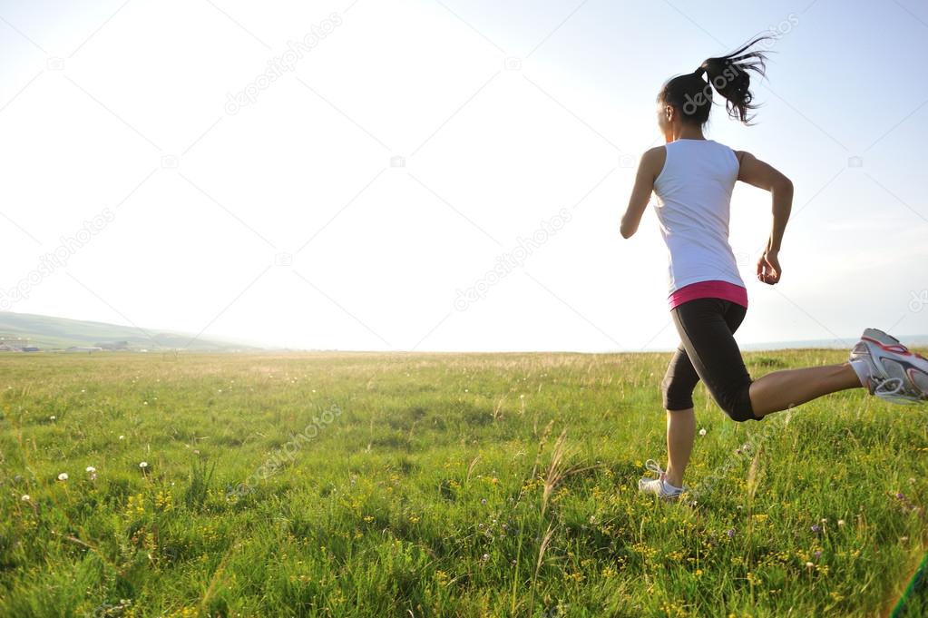 Runner athlet running on grass seaside.