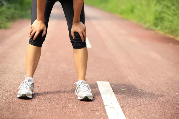 Mujer sostener su rodilla lesionada — Foto de Stock