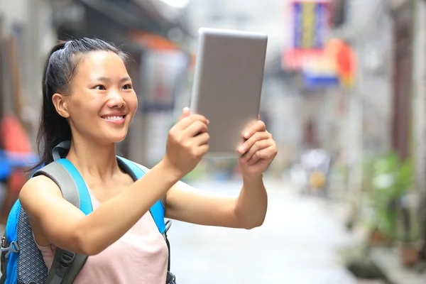 Woman tourist hold blank digital tablet