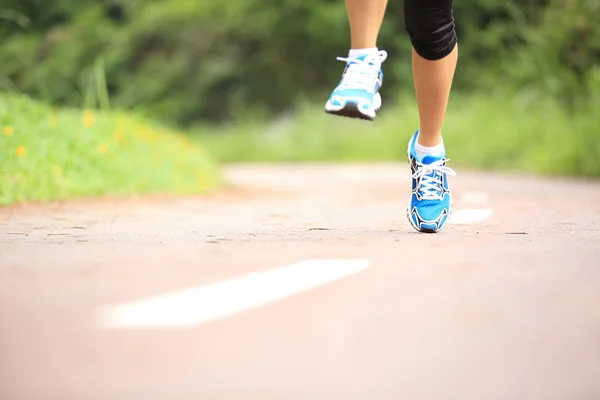 Oung fitness piernas de mujer corriendo en el sendero del bosque —  Fotos de Stock