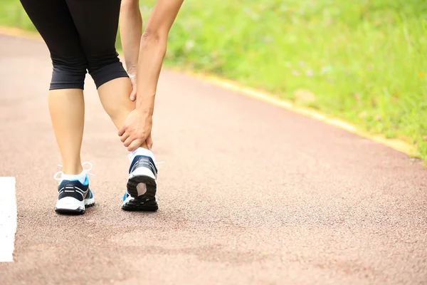Woman runner hold her twisted ankle — Stock Image Woman runner hold her twisted ankle Stock Image