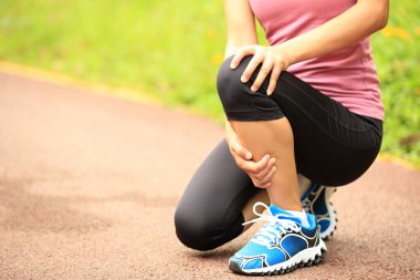 Woman runner hold her injured leg clipart