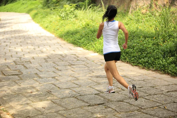Giovane donna fitness che corre al sentiero della foresta — Foto Stock