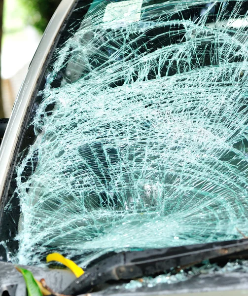 Broken windshield of car by typhoon