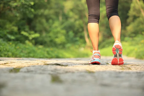 Jeune femme fitness jambes en cours d'exécution au sentier forestier — Photo