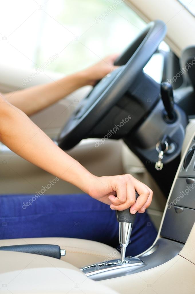 Woman driver shifting the gear stick