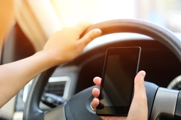 Женщина-водитель использует свой мобильный телефон — стоковое фото